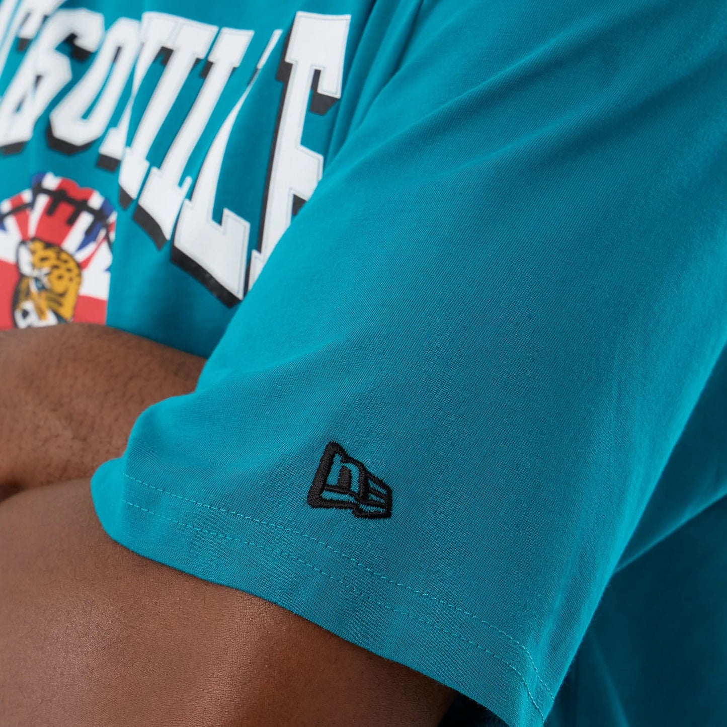 The Male model is wearing Jacksonville Jaguars NFL International Series Games Turquoise Oversized T-Shirt 4