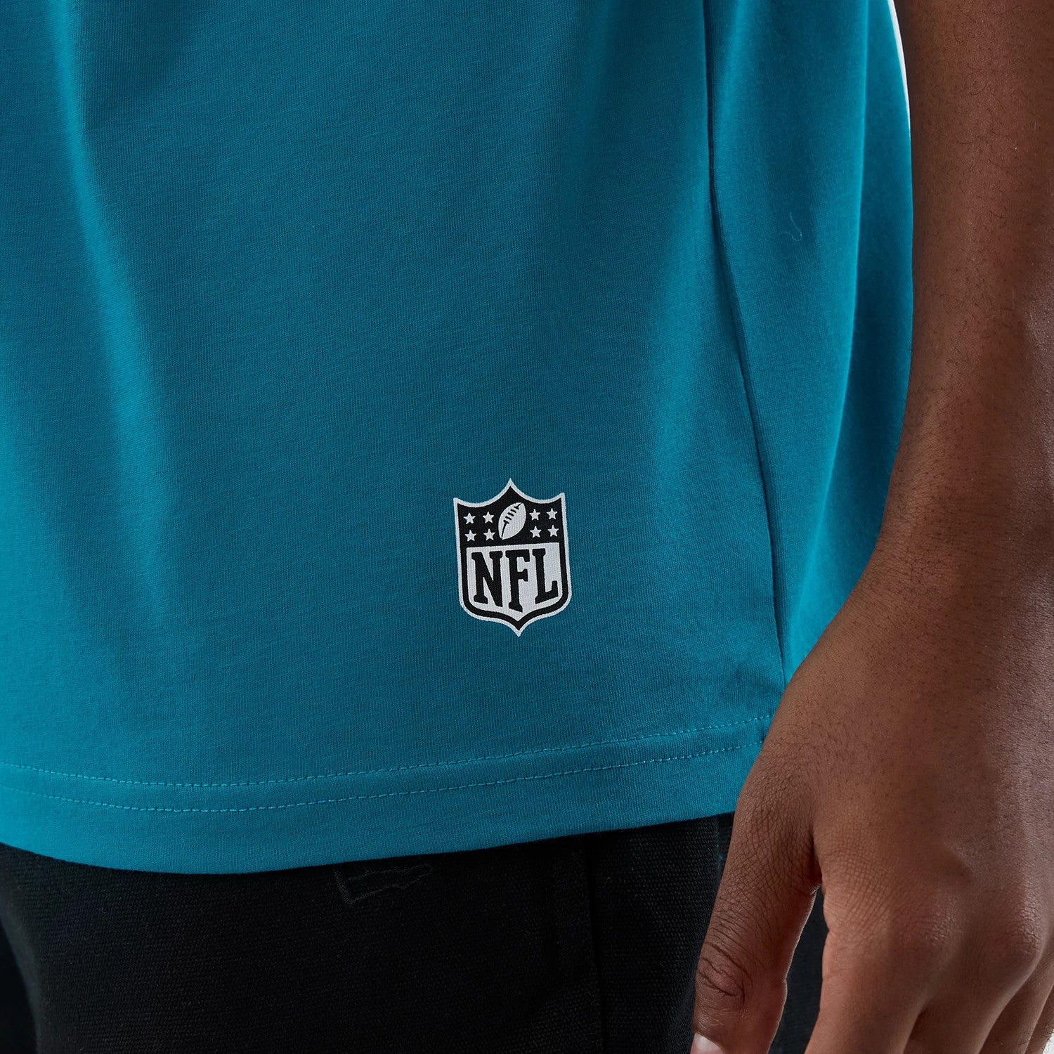 The Male model is wearing Jacksonville Jaguars NFL International Series Games Turquoise Oversized T-Shirt 5