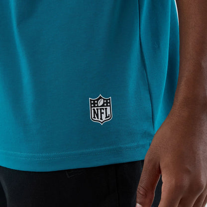 The Male model is wearing Jacksonville Jaguars NFL International Series Games Turquoise Oversized T-Shirt 5