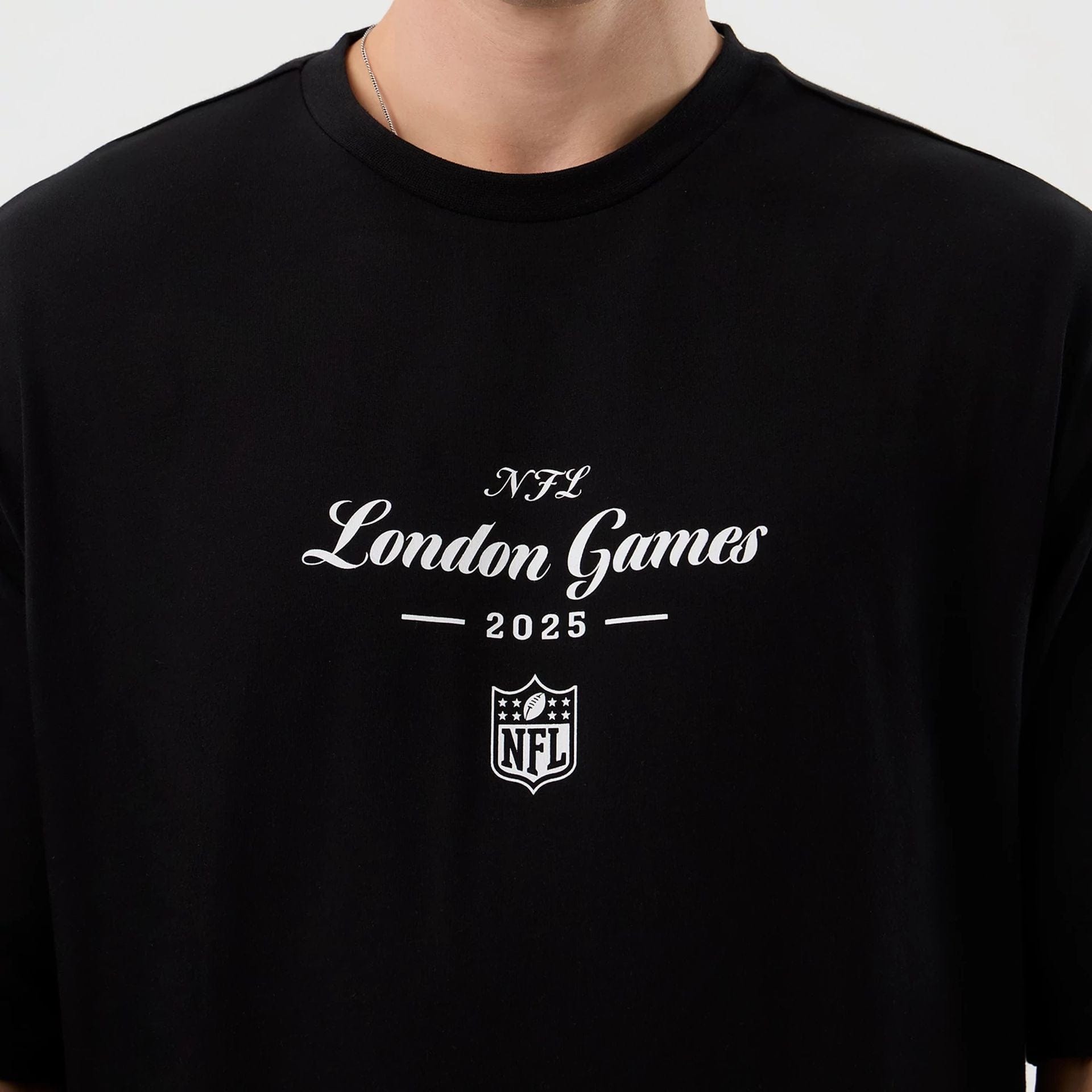The Male model is wearing London Games NFL International Series Games Black Oversized T-Shirt  3
