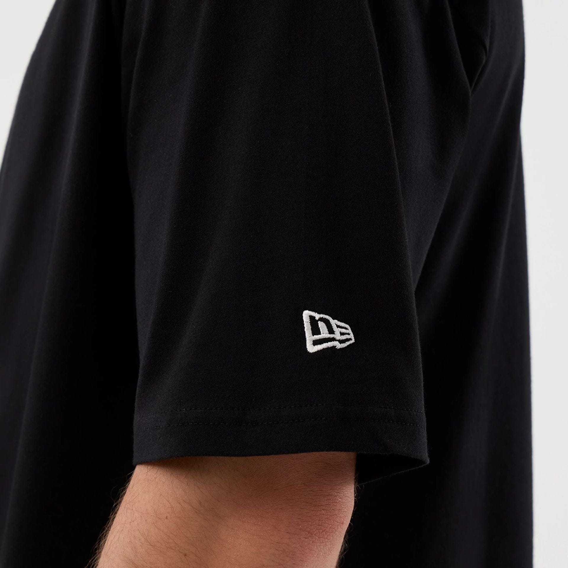 The Male model is wearing Madrid Game NFL International Series Games Black Oversized T-Shirt  5