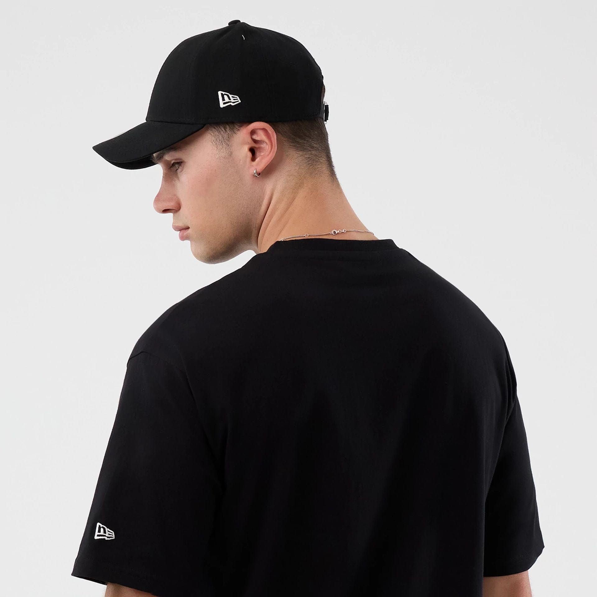 The Male model is wearing Madrid Game NFL International Series Games Black Oversized T-Shirt  7