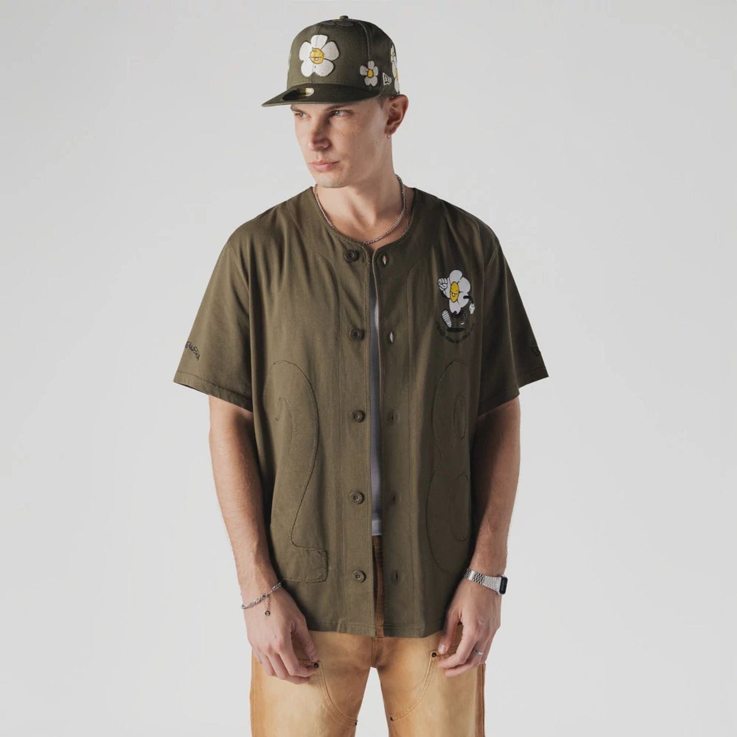 The Male model is wearing  New Era x Rodrigo Roji Flower Green Jersey  1