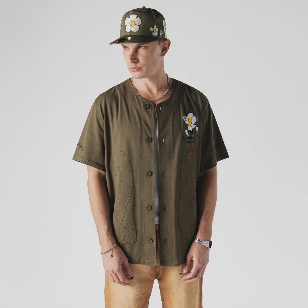 The Male model is wearing  New Era x Rodrigo Roji Flower Green Jersey 1