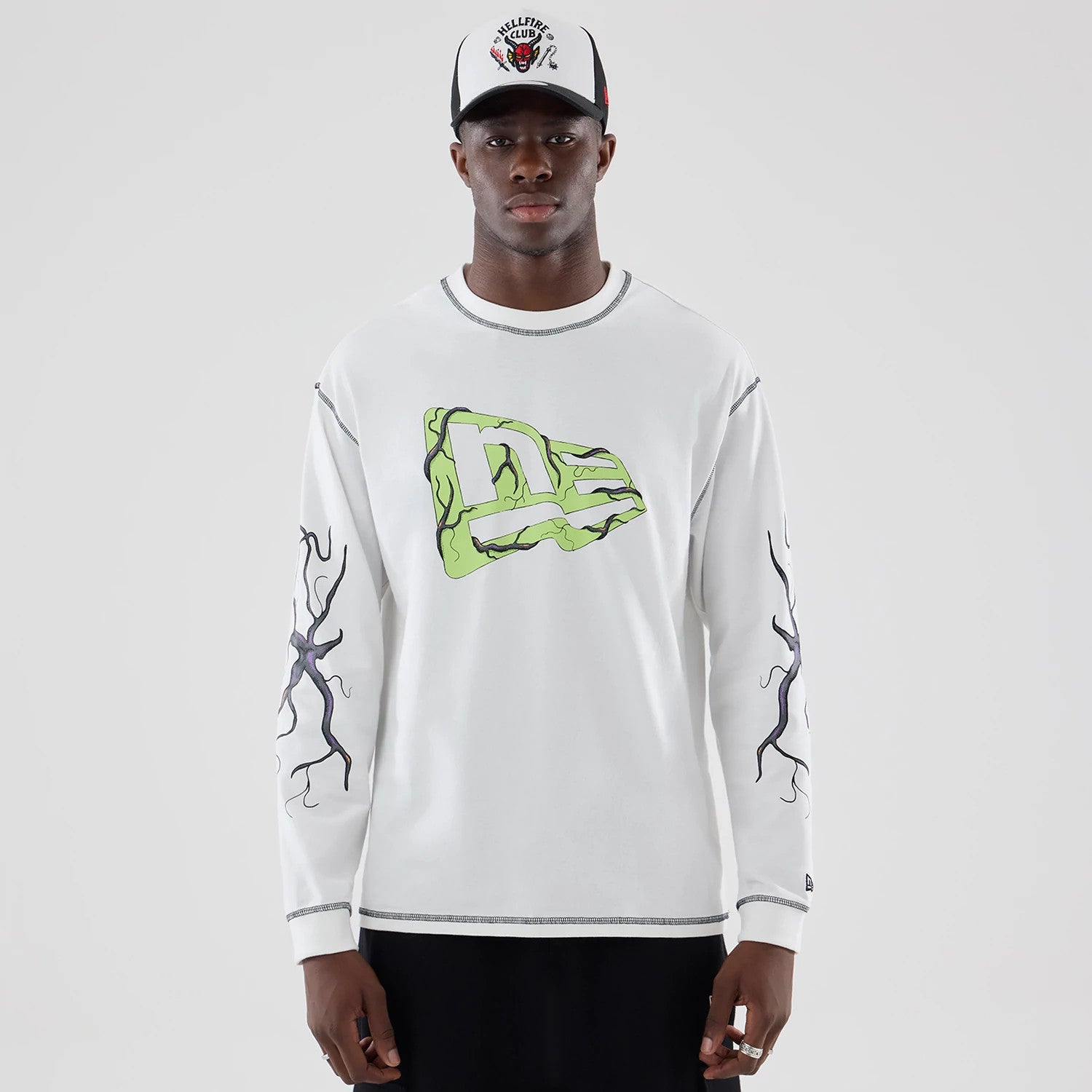 The Male model is wearing Stranger Things White Oversized Long Sleeve T-Shirt 1