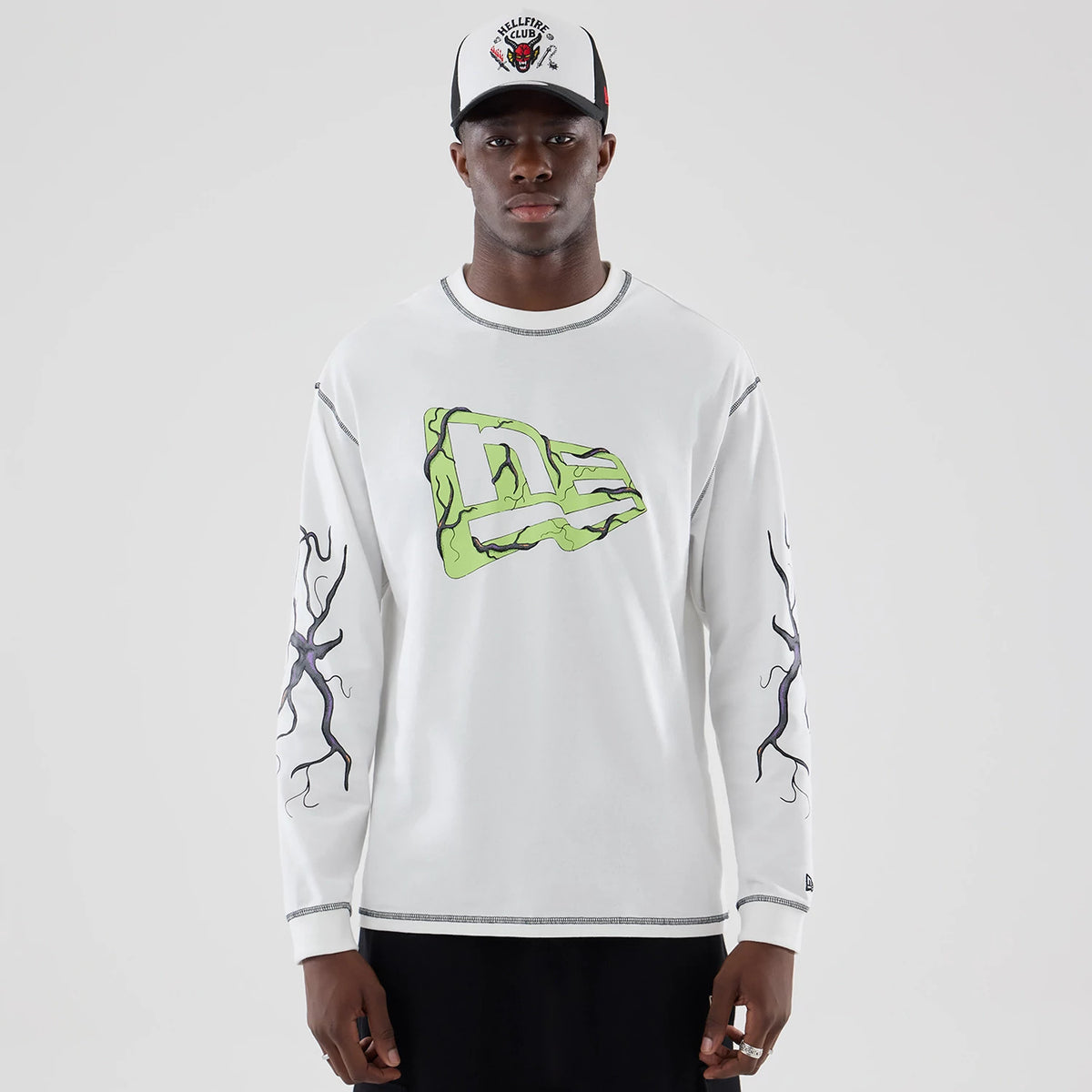 The Male model is wearing Stranger Things White Oversized Long Sleeve T-Shirt 1