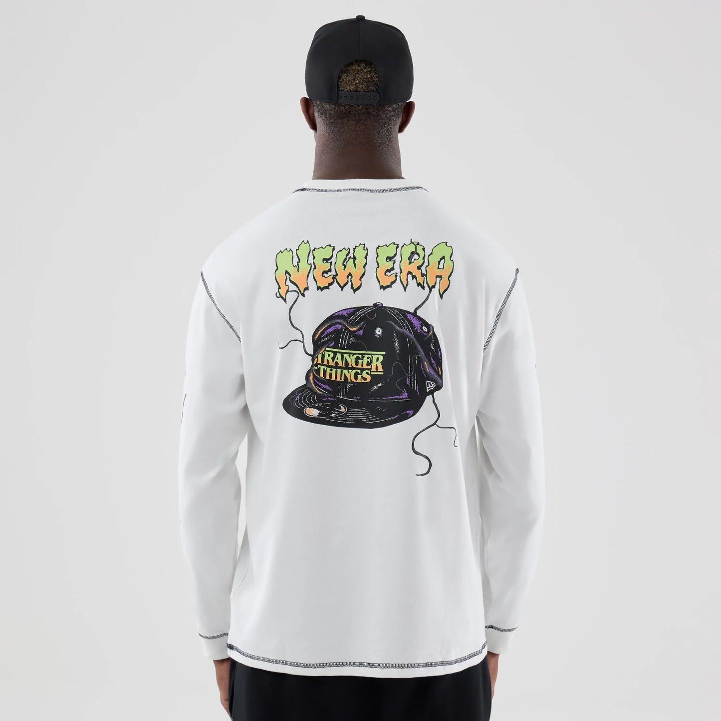 The Male model is wearing Stranger Things White Oversized Long Sleeve T-Shirt 2