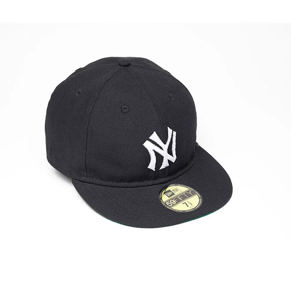 New York Yankees MLB Soft Black New Era 59FIFTY Fitted Cap, three-quarter view showing the white raised embroidered NY logo on the front panel, a flat black visor with a gold 59FIFTY size sticker, and eyelets on the structured crown.