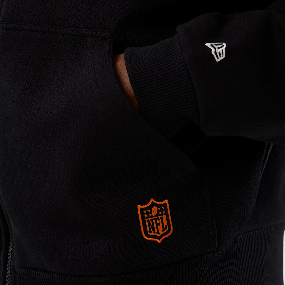 New Era Cleveland Browns NFL International Series Games Black Full Zip Hoodie, front view showing an orange embroidered NFL logo near the pocket and a white embroidered New Era logo on the sleeve cuff.