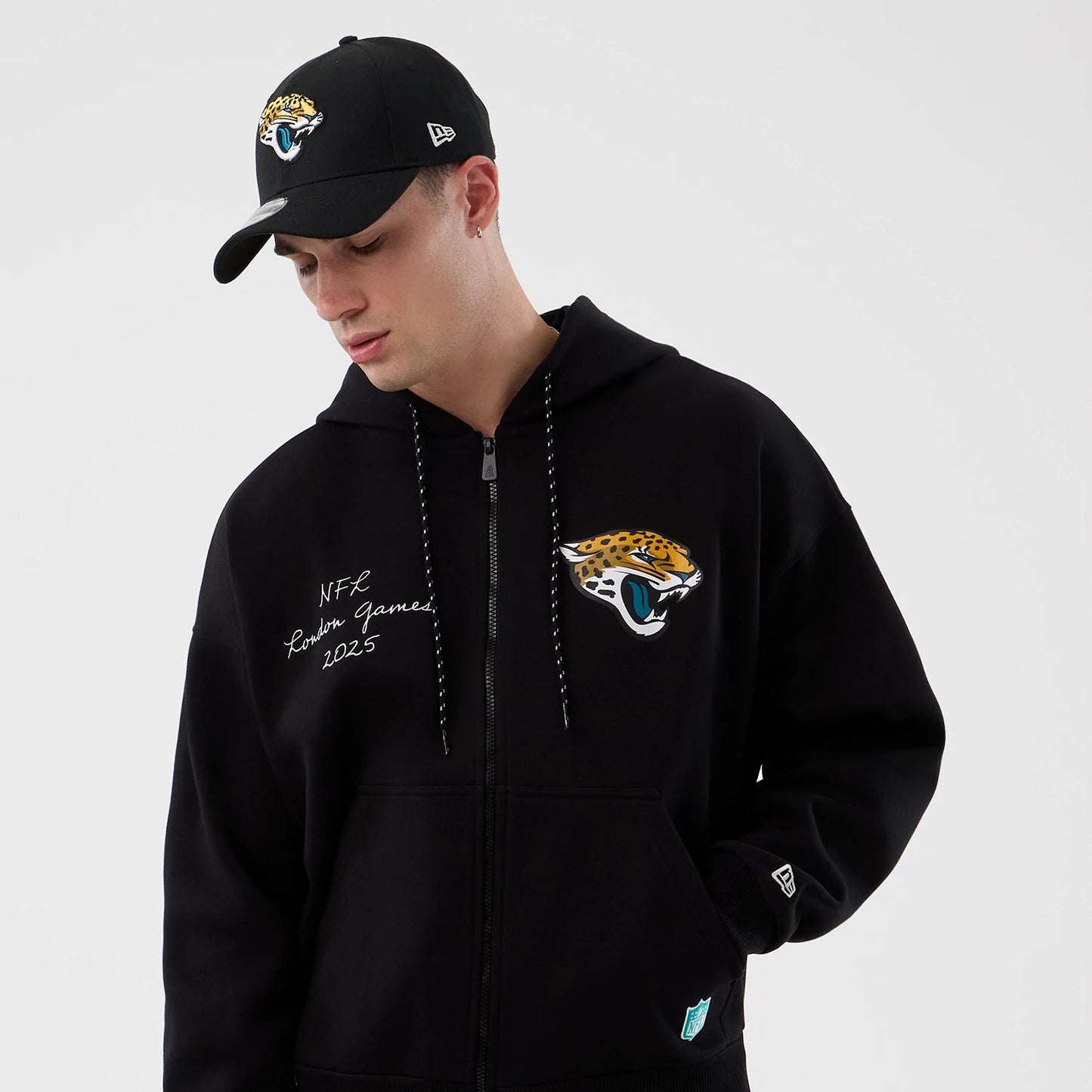 The Male model is wearing Jacksonville Jaguars NFL International Series Games Black Full Zip Hoodie 5