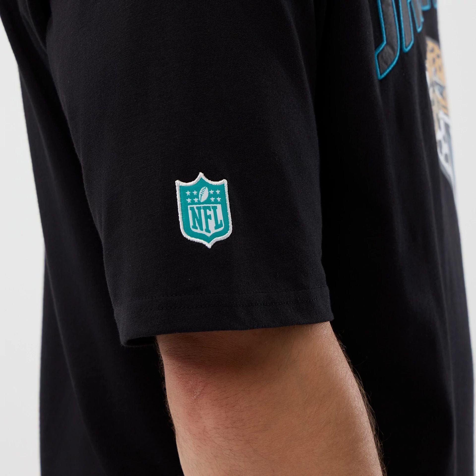 The Male model is wearing Jacksonville Jaguars NFL International Series Games Black Oversized T-Shirt  4