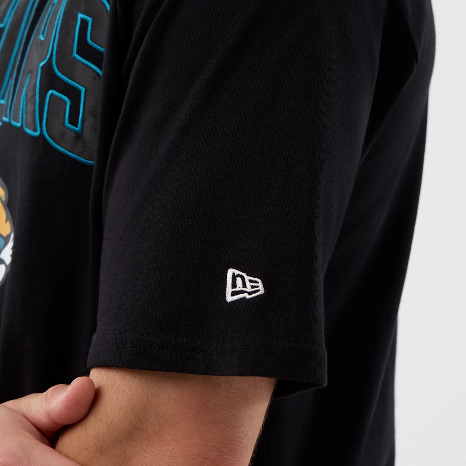 The Male model is wearing Jacksonville Jaguars NFL International Series Games Script Black Oversized T-Shirt 5