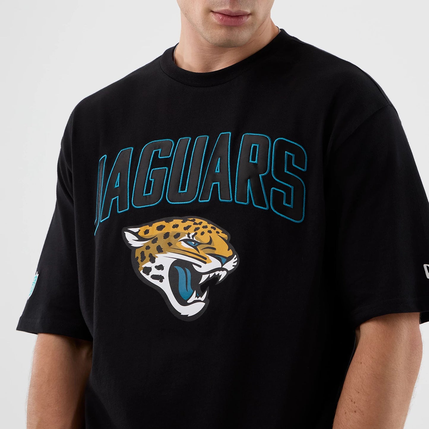 The Male model is wearing Jacksonville Jaguars NFL International Series Games Script Black Oversized T-Shirt 3