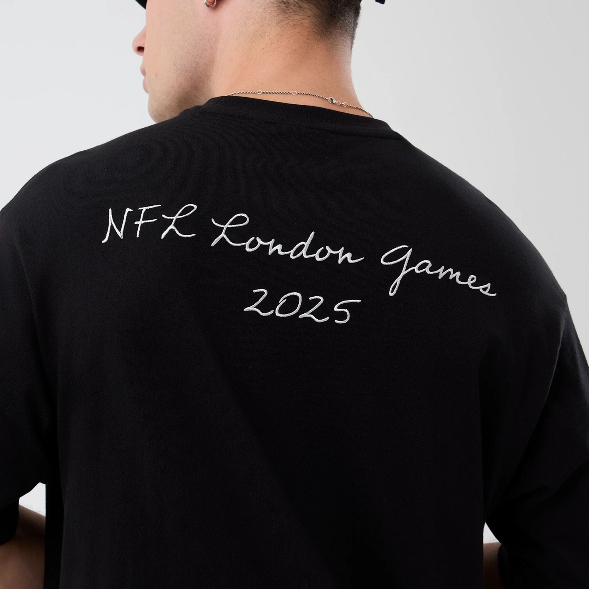 The Male model is wearing Jacksonville Jaguars NFL International Series Games Black Oversized T-Shirt  7