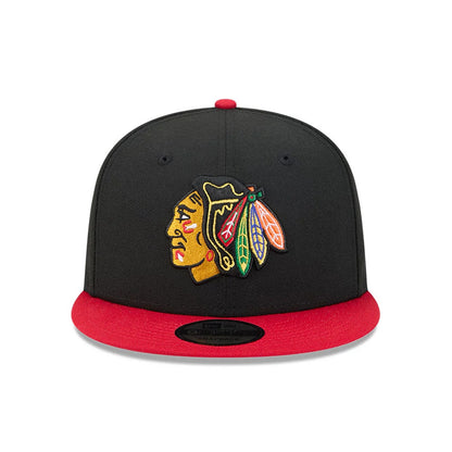 Chicago Blackhawks NHL Evergreen Black New Era 9FIFTY Snapback Adjustable Cap, front view showing the team logo embroidered in colours on the structured black crown, with a bright red visor and black 9FIFTY size sticker.