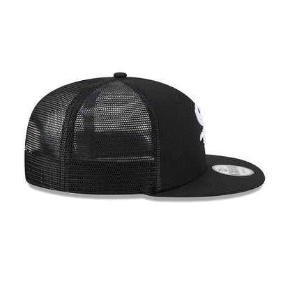 Chicago White Sox MLB Evergreen Black New Era 9FIFTY Trucker Adjustable Cap, side view showing the white embroidered logo on the front panel, black mesh back panels, and flat black visor with 9FIFTY size sticker.