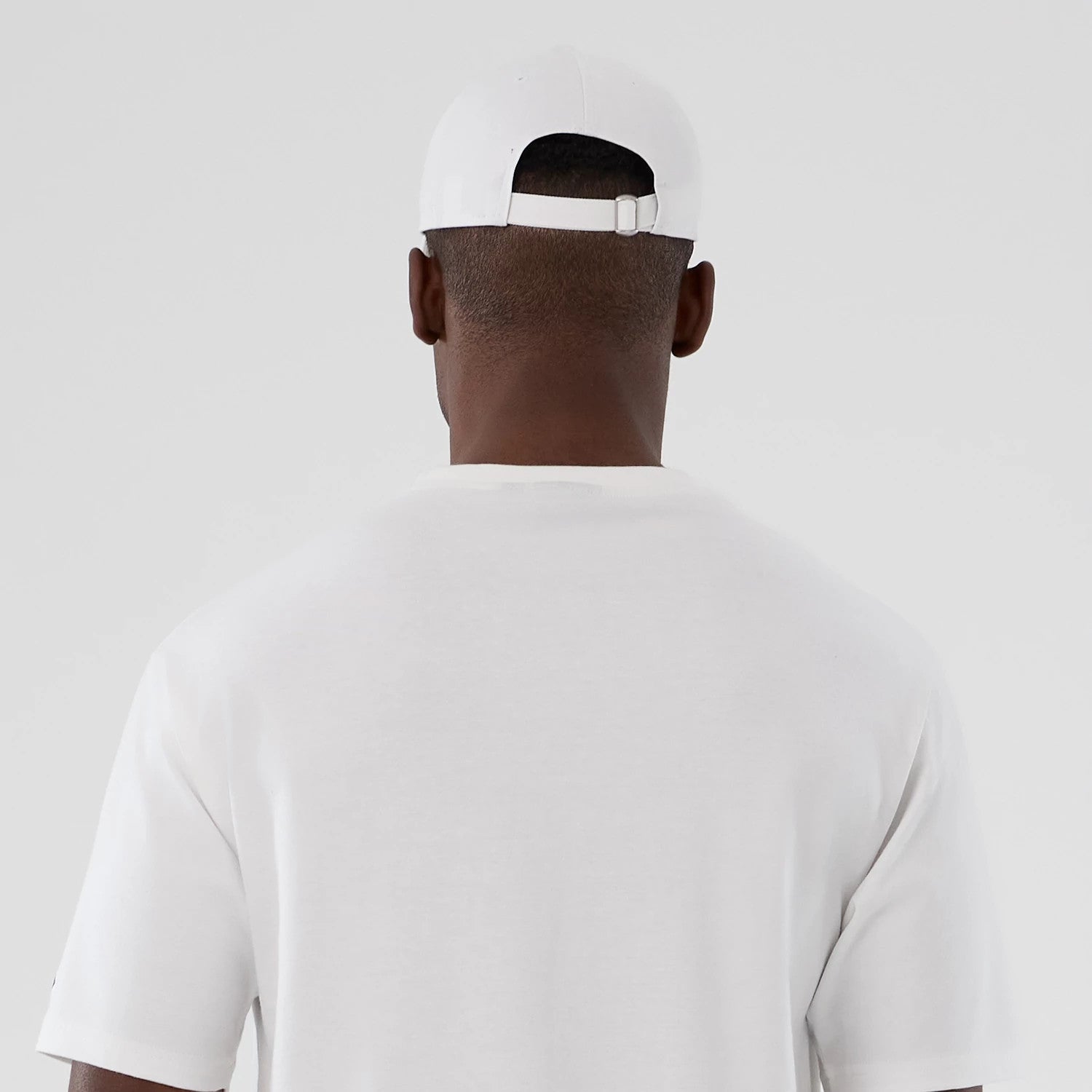 The Male model is wearing  New Era Halloween Skull Graphic White Oversized T-Shirt 7