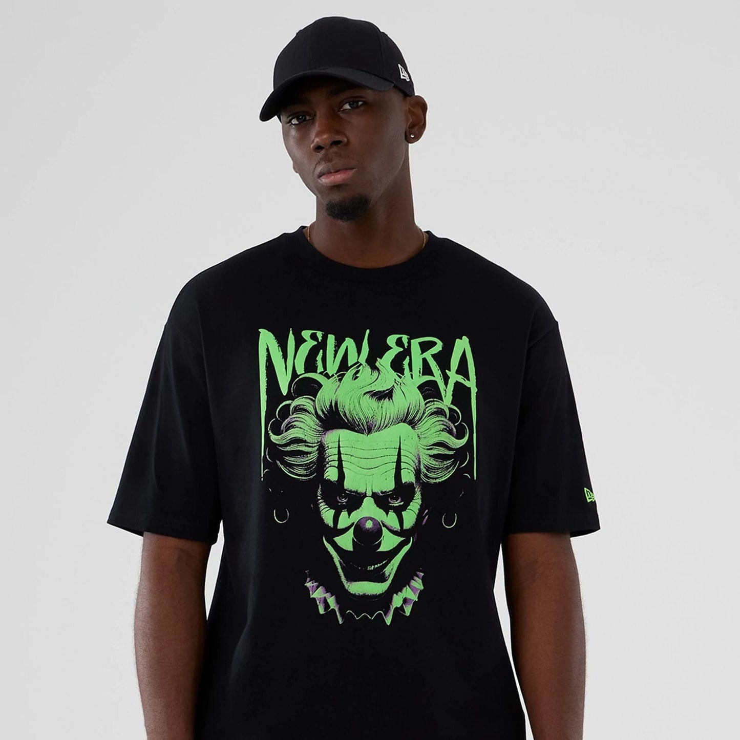 The Male model is wearing  New Era Halloween Clown Graphic Black Oversized T-Shirt  7