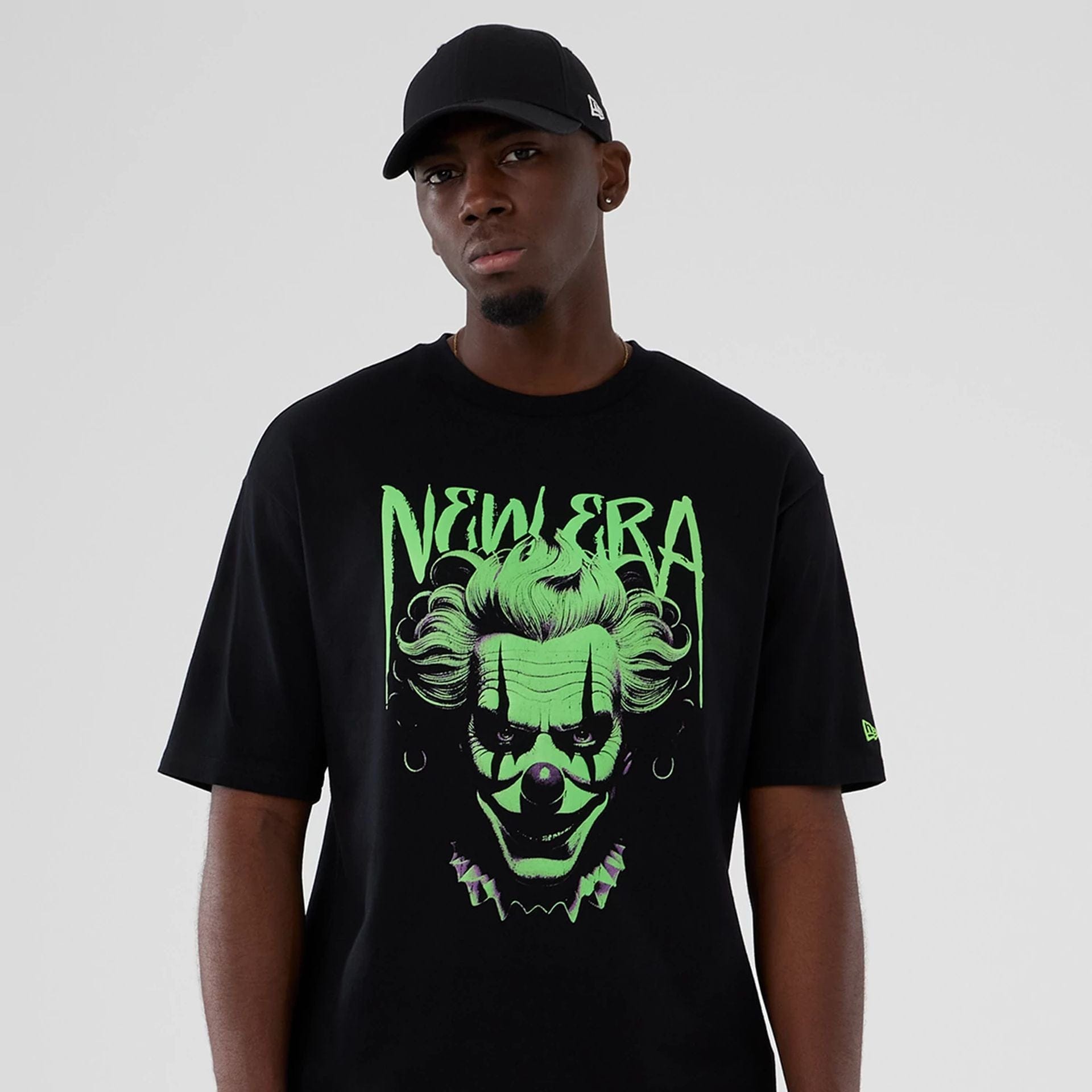 The Male model is wearing  New Era Halloween Clown Graphic Black Oversized T-Shirt  7