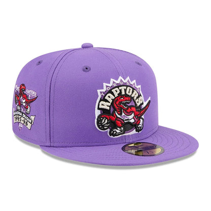 Pictured is this NBA Hardwood Classic Toronto Raptors 59FIFTY Fitted cap in bright purple. 1