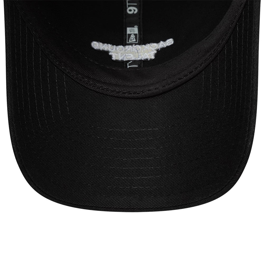 New Era Slogan Background Talent Black 9TWENTY Adjustable Cap, inside view showing the black undervisor, detailed white text on the reverse side of the front panel, and the black sweatband with a white New Era tag along the seam.