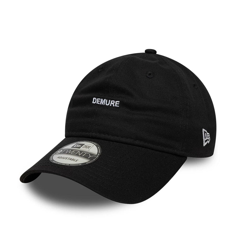 This is a  New Era Slogan Demure Black 9TWENTY Adjustable Cap 1