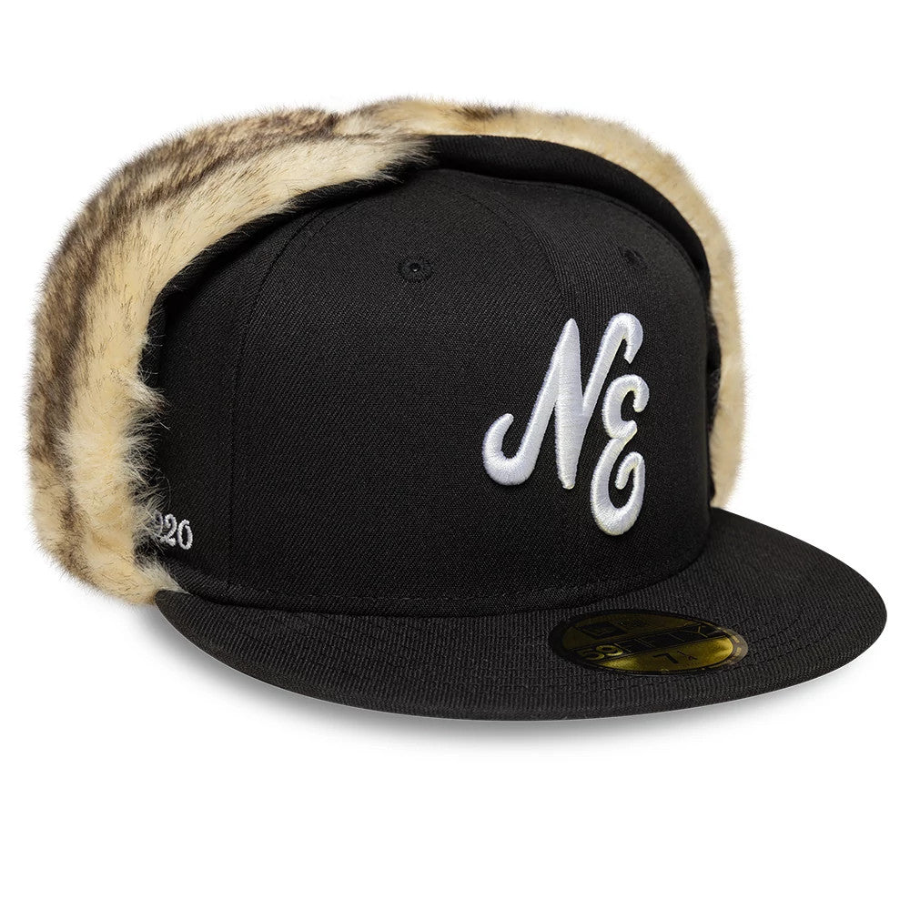 New Era Black Dogear 59FIFTY Fitted Cap, three-quarter view showing a white embroidered NE logo on the front panel, surrounded by furry ear flaps, with a flat black visor and a gold 59FIFTY size sticker.