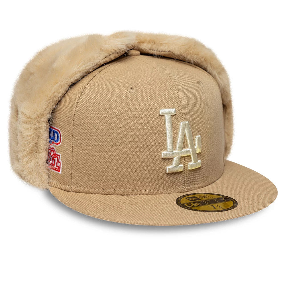 LA Dodgers MLB World Series Light Beige New Era 59FIFTY Fitted Cap, three-quarter view showing the cream embroidered LA logo prominently on the front panel, beige fur-lined ear flaps, and a gold 59FIFTY size sticker on the visor.
