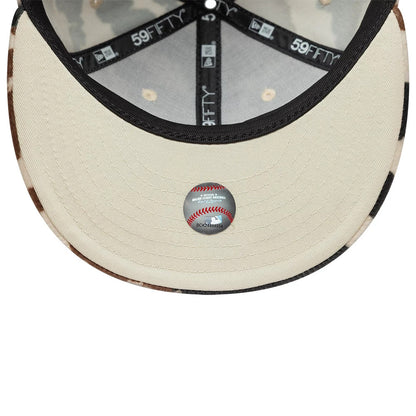 New York Yankees Animal Print Cow Beige New Era 59FIFTY Fitted Cap, inside view showing the beige undervisor with a baseball sticker, black branded taping, and cow print pattern on the inner edge of the visor.