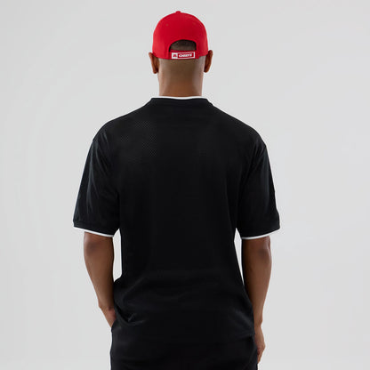 The model is wearing this NFL Mesh Kansas City Chiefs Oversized T-Shirt in black. 2