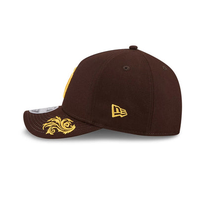 San Diego Padres MLB Script Dark Brown New Era 9FORTY M-Crown A-Frame Adjustable Cap, side view showing the yellow embroidered New Era flag logo on the left side and an ornate yellow design on the brown curved visor.