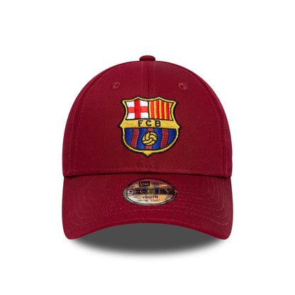 FC Barcelona Youth Core Dark Red New Era 9FORTY Adjustable Cap, front view showing the embroidered multicoloured club crest on the structured dark red crown, with a curved visor and 9FORTY size sticker on the visor.