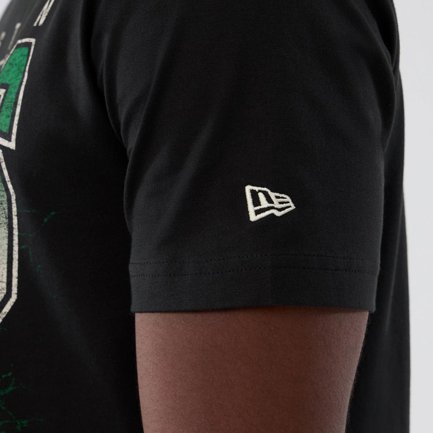 The model is wearing this NBA Hardwood Classic Boston Celtics T-Shirt in black. 4