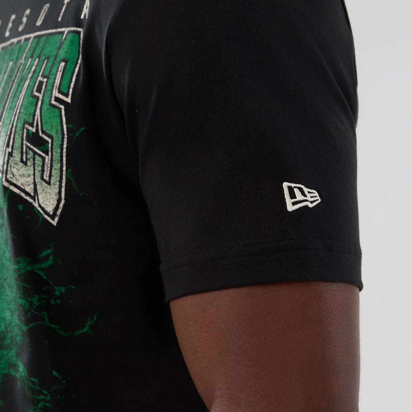 The model is wearing this NBA Hardwood Classic Minnesota Timberwolves T-Shirt in black. 4