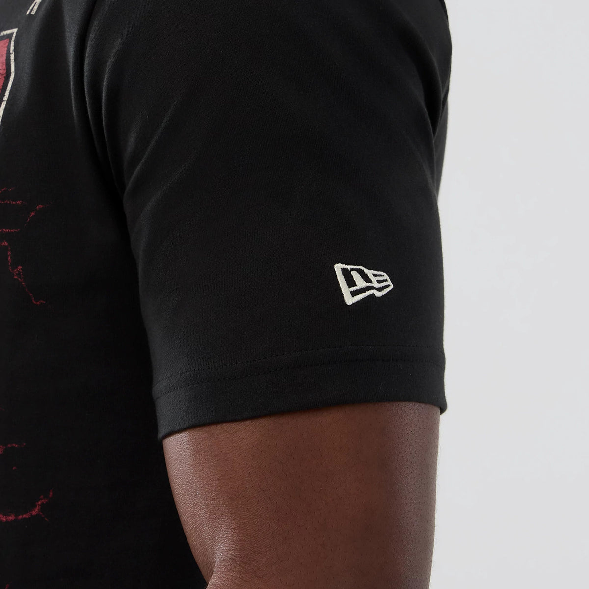 New Era Denver Nuggets NBA Hardwood Classic Black T-Shirt, three-quarter view focuses on the short sleeve of the black T-shirt with an embroidered white New Era logo placed near the hem of the sleeve.