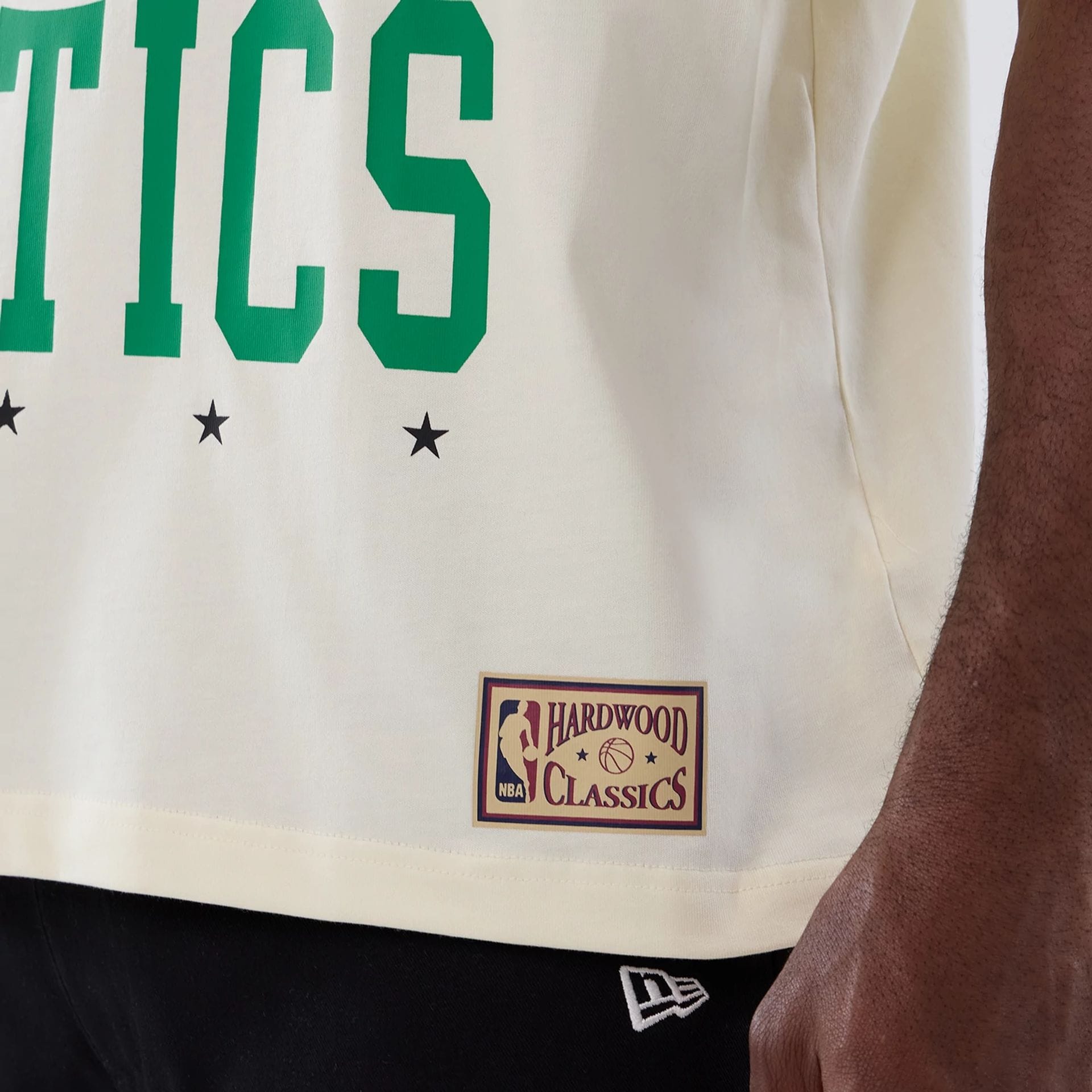 The model is wearing this NBA Hardwood Classic Boston Celtics T-Shirt in cream. 5