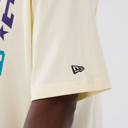 The model is wearing this NBA Hardwood Classic Charlotte Hornets T-Shirt in cream. 4