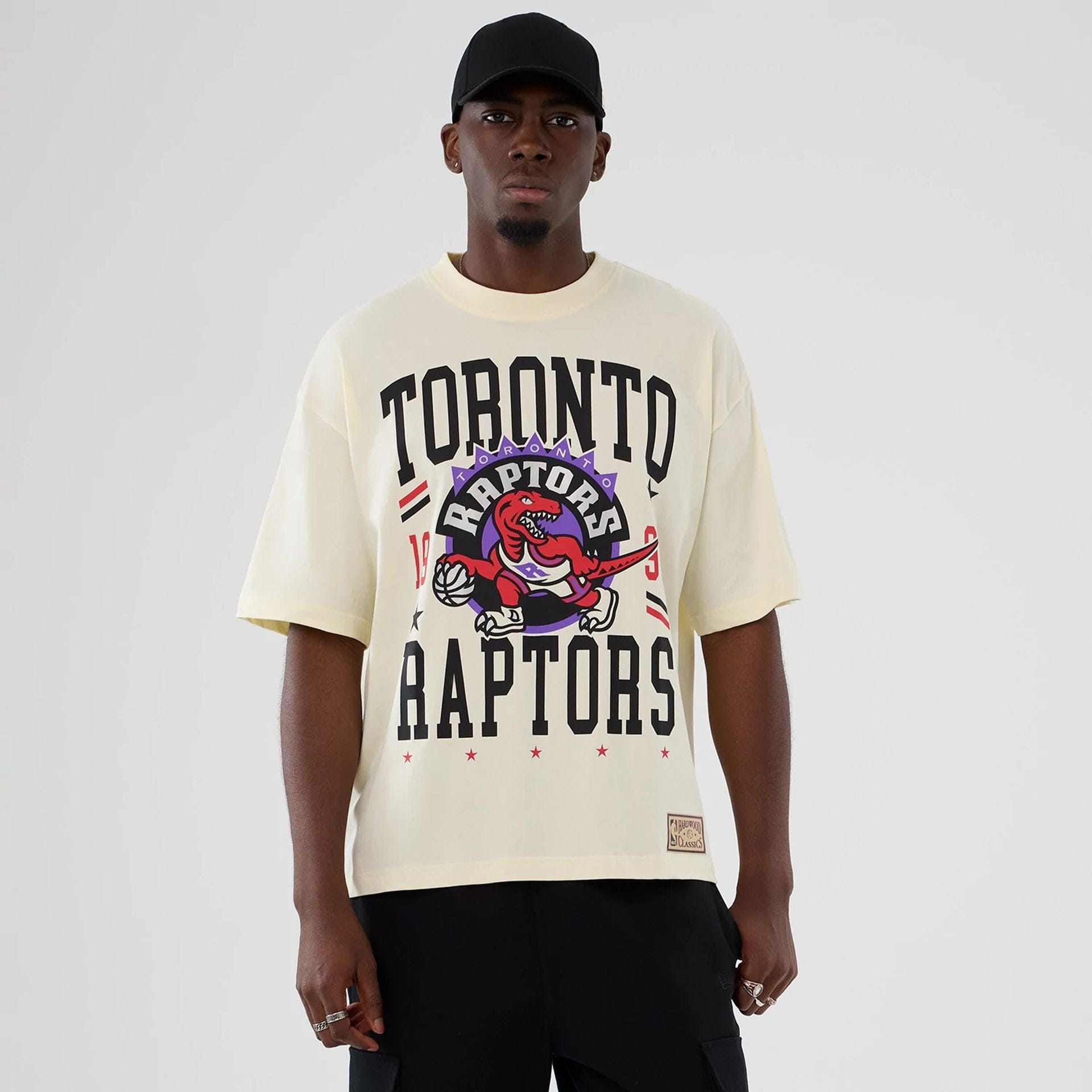The model is wearing this NBA Hardwood Classic Toronto Raptors T-Shirt in Cream . 1