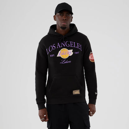 The model is wearing this NBA Hardwood Classic LA Lakers Pullover Hoodie in black. 1