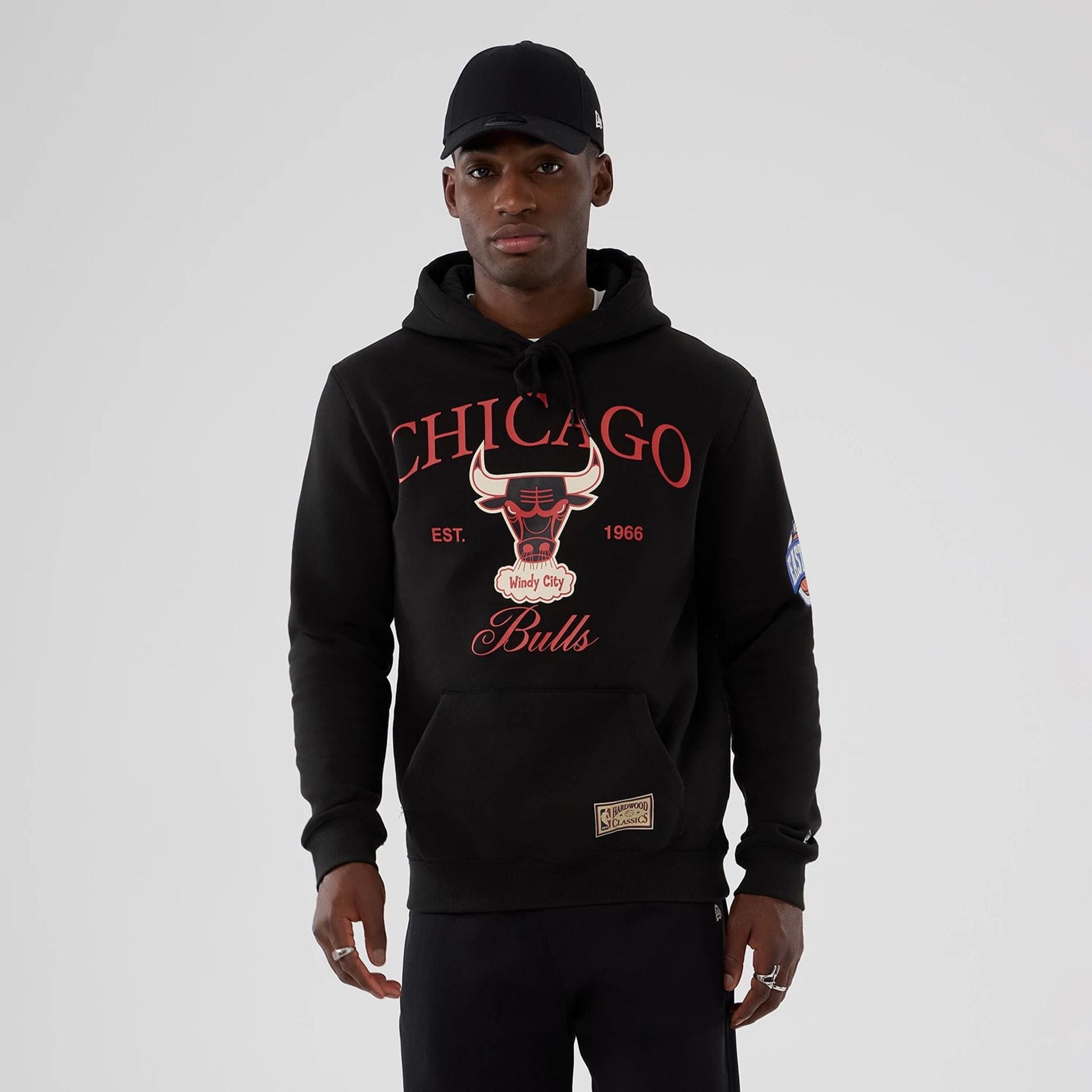 The model is wearing this NBA Hardwood Classic Chicago Bulls Pullover Hoodie in black. 1