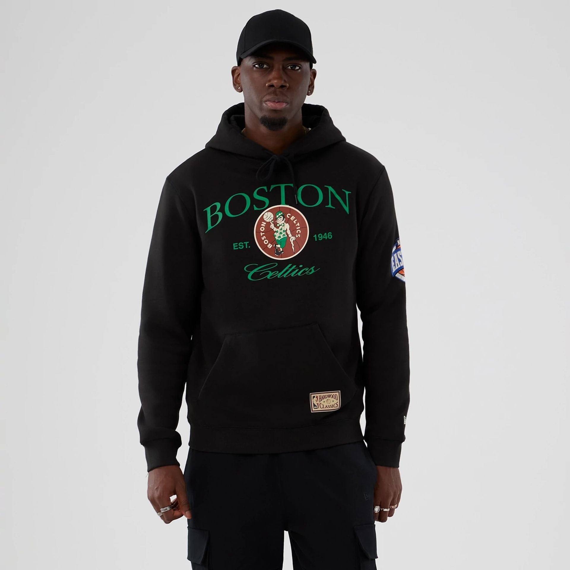 The model is wearing this NBA Hardwood Classic Boston Celtics Pullover Hoodie in black. 1