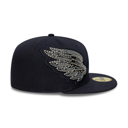 New Era Beaded Wings Navy 59FIFTY Fitted Cap, side view showing silver beaded wing design embroidered on the front panel against the structured navy crown, with matching navy visor and gold 59FIFTY size sticker.