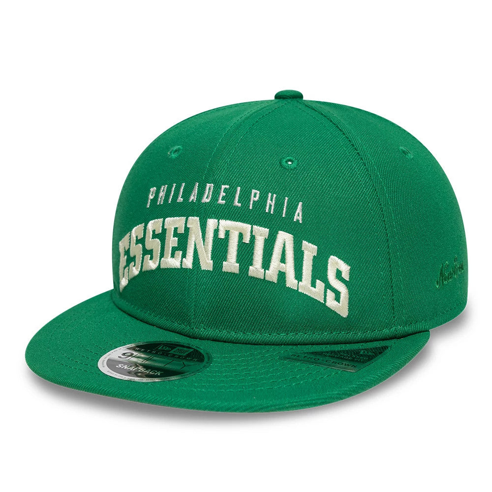 Philadelphia Eagles Fear Of God x NFL Green Retro Crown New Era 9FIFTY Adjustable Cap, three-quarter view with raised white embroidered Philadelphia Essentials lettering on the structured green crown and a 9FIFTY size sticker on the flat visor.
