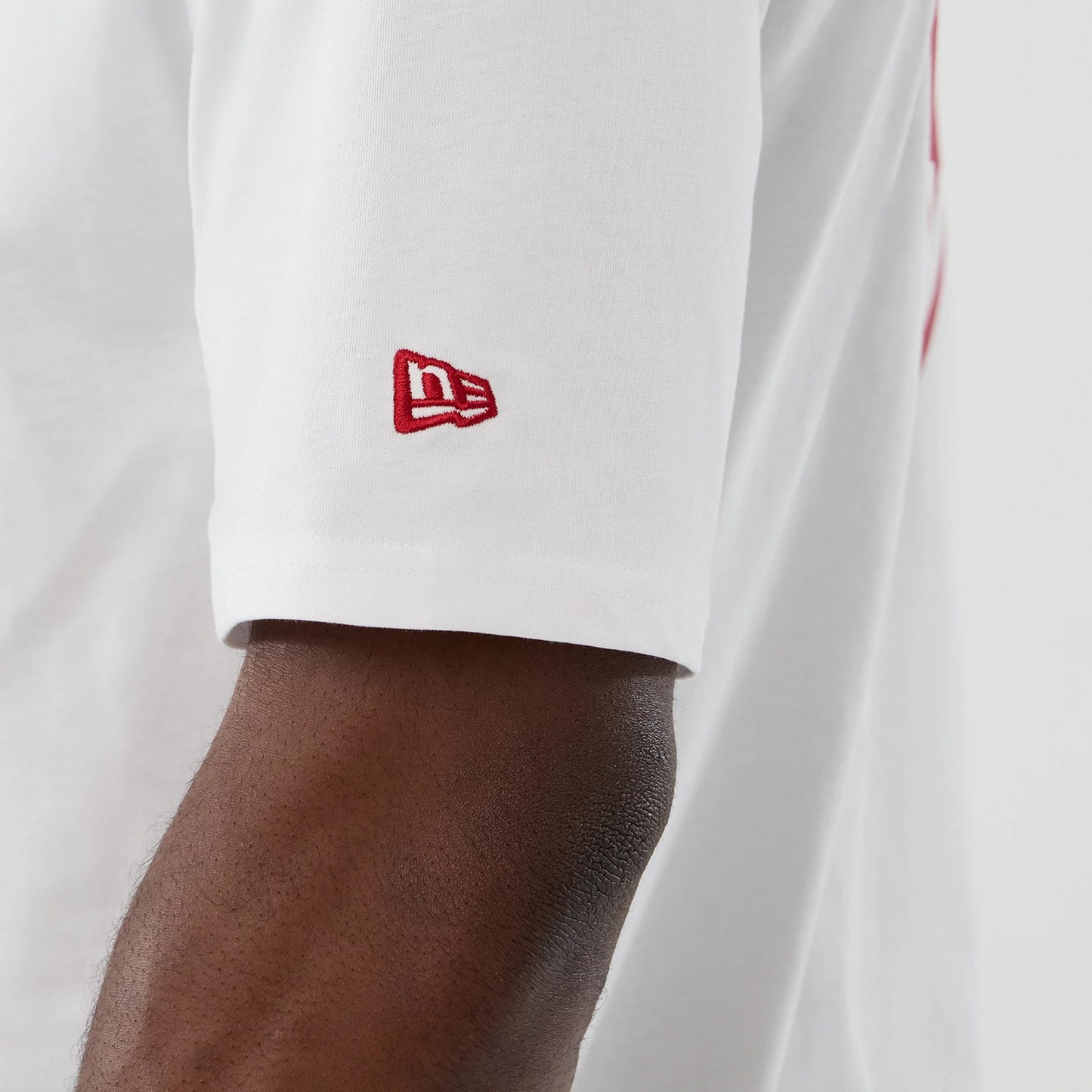 The Male model is wearing Atlanta Falcons NFL International Series Games 2025 White Oversized T-Shirt 6