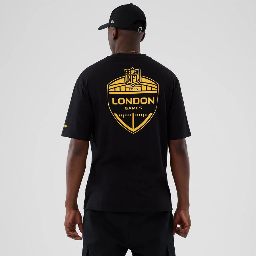 The Male model is wearing Minnesota Vikings NFL International Series Games 2025 Black Oversized T-Shirt  2