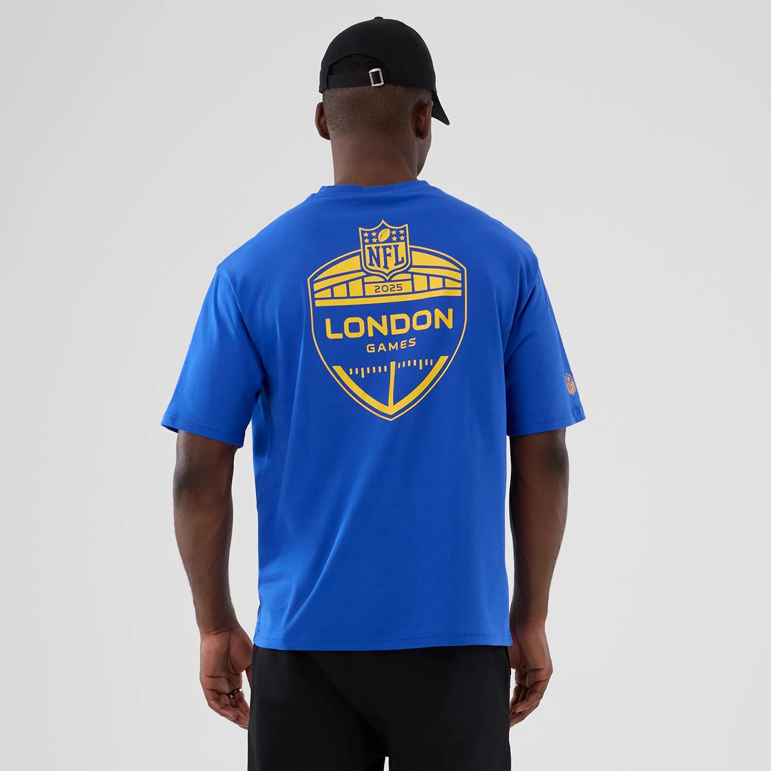 The Male model is wearing LA Rams NFL International Series Games 2025 Bright Blue Oversized T-Shirt 2