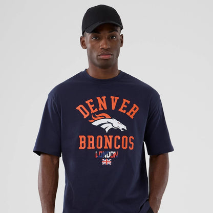 The Male model is wearing Denver Broncos NFL International Series Games 2025 Navy Oversized T-Shirt  7