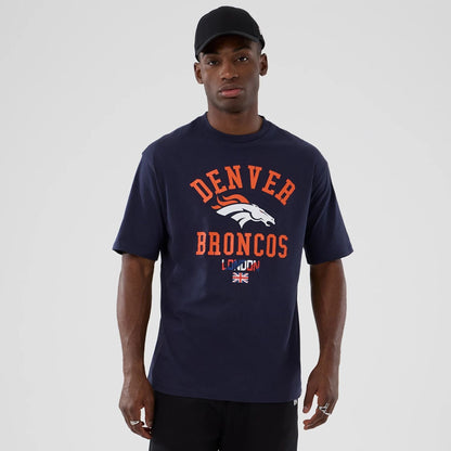 The Male model is wearing Denver Broncos NFL International Series Games 2025 Navy Oversized T-Shirt  1