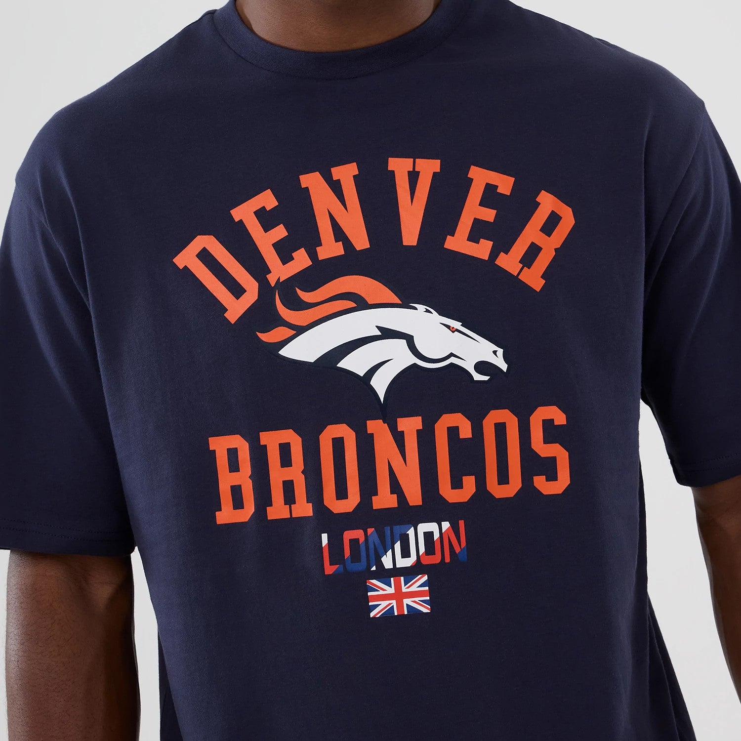 The Male model is wearing Denver Broncos NFL International Series Games 2025 Navy Oversized T-Shirt 3