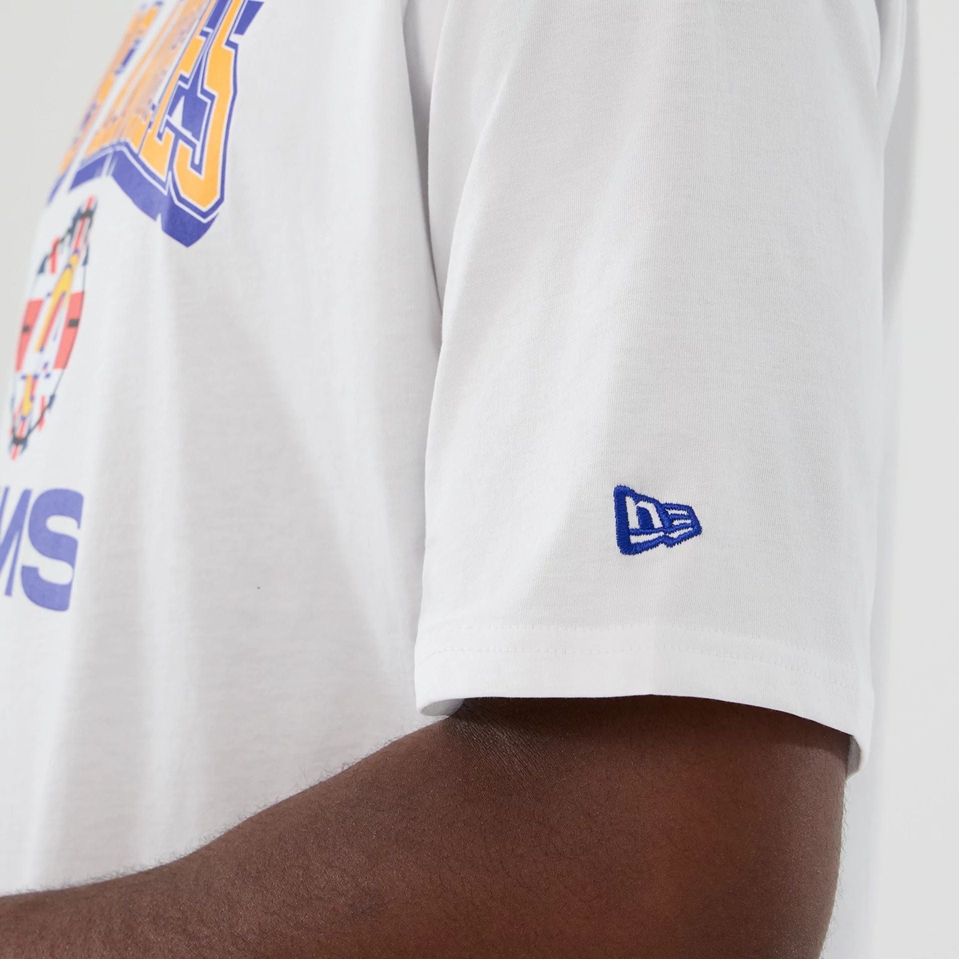 The Male model is wearing LA Rams NFL International Series Games 2025 White Oversized T-Shirt  7